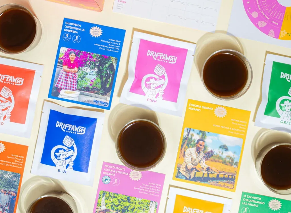 Driftaway Coffee bags and brewed cups laid out with origin cards for Guatemala, Ethiopia, and Mexico